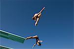 Two women diving from diving board