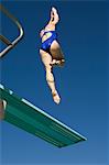 Female swimmer jumping on diving boards