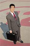 Business man standing in parking lot