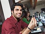 Young people eating sushi with chopsticks in restaurant