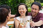 Two couples toasting in garden