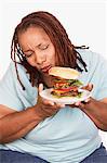 Overweight Woman holding hamburger