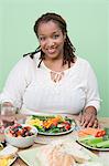 Overweight mid-adult woman having healthy meal