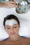 Woman having facial treatment at health spa