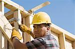 Construction worker using hammer on building