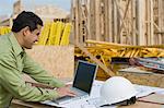 Construction worker using laptop