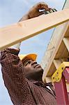 Construction worker using spirit level on building