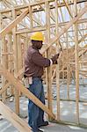 Construction worker hammering framework