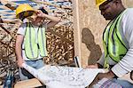 Two construction workers studying blueprints