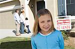 Portrait of pre-teen girl (7-9) in front of new house