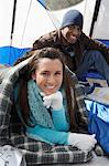 Young couple relaxing in tent.