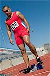 Male sprinter preparing to start