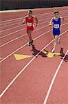 Male sprinters running on track