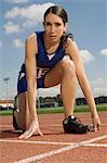 Female track athlete preparing for sprint