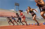 Group of female track athletes sprinting