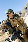 Soldier using field phone in mountains