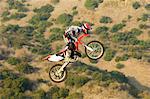 Motocross racer in mid-air over desert