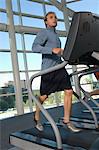 Man Jogging on Treadmill at Gym