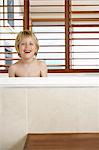 Smiling Boy sitting in Bathtub