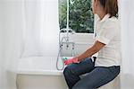 Young woman cleaning bathroom