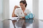 Woman with stain on blouse at dining room table