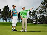 Two male golfers on green