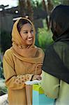 Two young muslim women talking outdoors