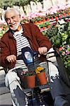 Elderly man on motor scooter in garden center