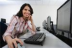 Woman sitting at desk in front of computer