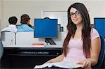 Female student sitting in computer classroom, portrait