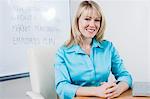 Woman Sitting in Front of Whiteboard