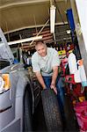 Auto Mechanic Changing a Tire