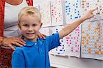 Little Boy Pointing to a Calendar Date for Teacher