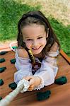 Little Girl Climbing a Rope