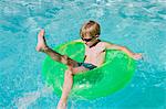 Boy on Float Tube in Swimming Pool
