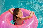 Girl Inside Pink Float Tube in Pool