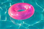 Pink Float Tube Floating in Swimming Pool