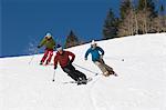 Skiers Skiing Down Slope