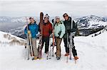 Skiers Holding Skis on Mountain