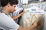 Young man working in dry cleaners