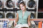 Portrait of young woman at launderette