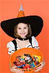 Portrait of girl (7-9) wearing witch costume for Halloween