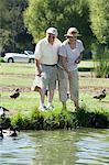 Senior couple feeding ducks
