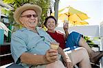 Senior couple sitting on bench and holding ice creams