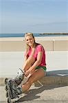 Young woman wearing rollerblades