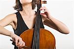 Mid section of female cellist