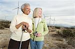 Women hiking near wind farm