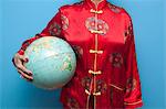 Woman in Chinese pajamas holding globe