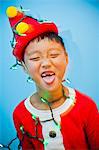 Boy in red costume with holiday lights