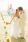 Bridal couple kissing on beach